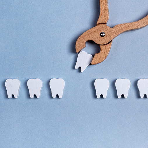 Wooden model representing a tooth extraction