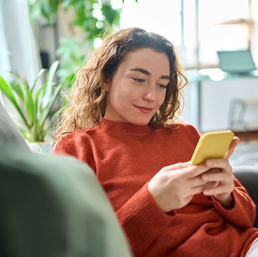 Woman relaxing on couch after tooth extraction