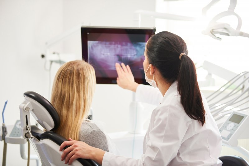 dentist speaking to patient about root canal retreatment